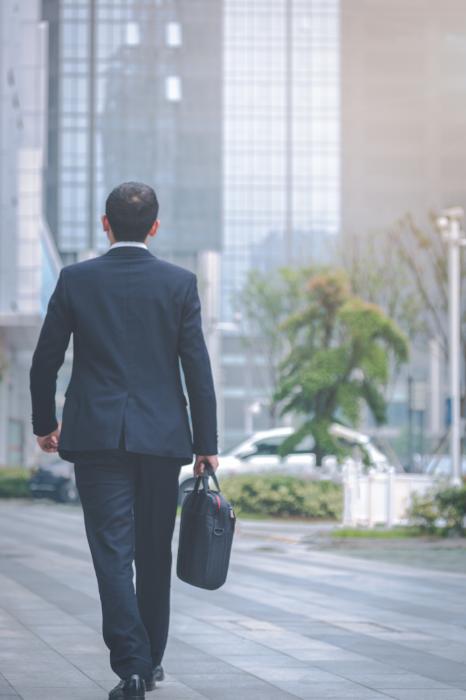 businessman leaving office with briefcase in hand financial advisor transitions